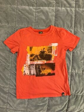 Charlie Rocket Orange Graphic Tee with Yellow Accents